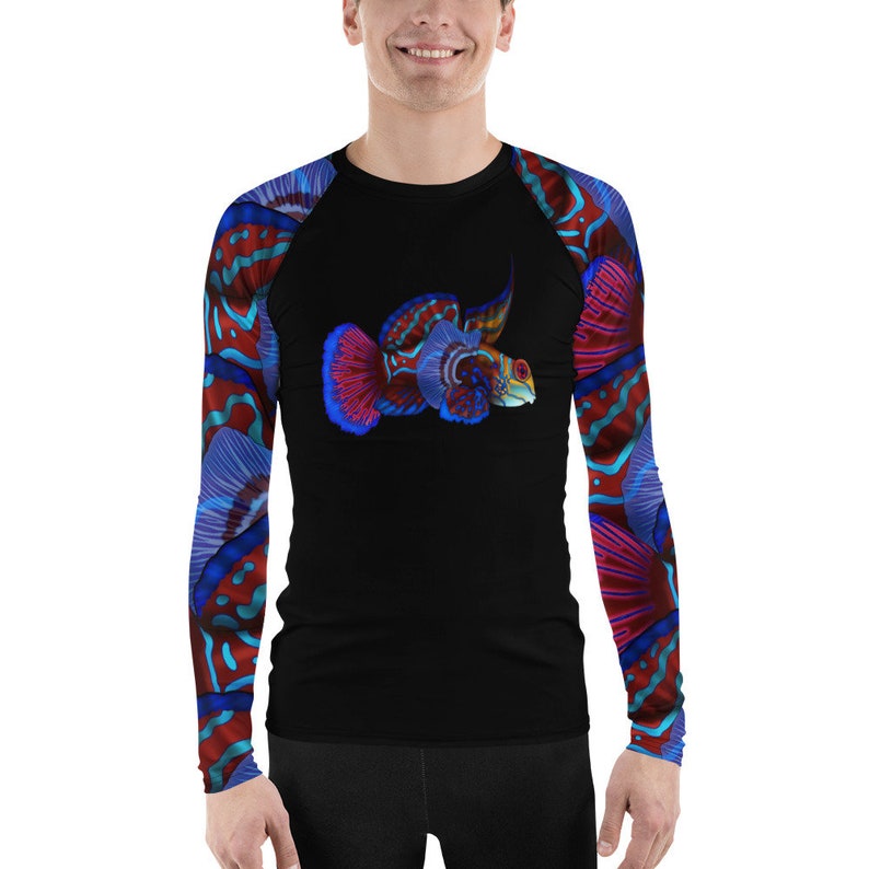 May include: A black long-sleeved shirt with a colorful fish design on the front and a repeating pattern of colorful coral on the sleeves.