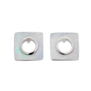 May include: A pair of silver square earrings with a round hole in the centre. The earrings are made of mother of pearl.