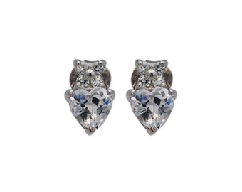 May include: A pair of silver stud earrings with a heart-shaped clear crystal and smaller clear crystals around the top of the heart.