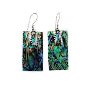 May include: A pair of silver earrings with rectangular abalone shell accents. The shell has a green, blue, and purple iridescent pattern. The silver has a textured design.