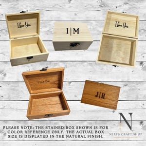 May include: Several wooden boxes are displayed, some open and some closed. The boxes are in various shades of brown and natural wood. Some boxes have the text "I Love You" engraved on the lid, while others have initials. The boxes have metal clasps.