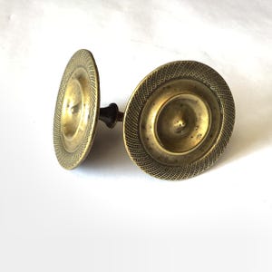 May include: A set of three ceramic mugs with a speckled, matte finish. Each mug features a different color: light blue, cream, and gray. The mugs have a simple, modern design with a rounded shape and a comfortable handle.