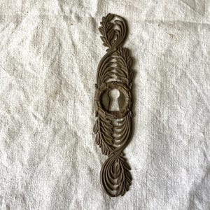 One large  Antique Brass Keyhole Cover made in France in the 1900s Black with patina