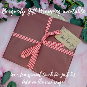May include: Burgundy gift wrapping with a red and white checkered ribbon and a gift tag that says "A little something special, Just for you". An extra special touch for just $3. Add on the cart page.