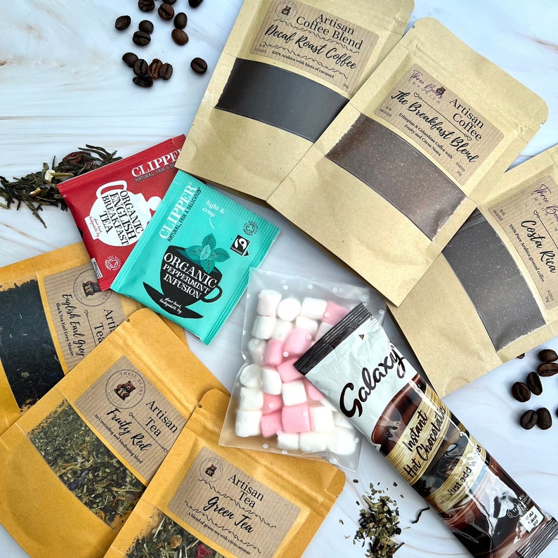 May include: A collection of artisan coffee and tea pouches, including Decaf Roast, Breakfast Blend, Costa Rica, English Earl Grey, Fruity Red, and Green Tea. Also features Clipper tea bags, a bag of mini marshmallows, and a Galaxy hot chocolate sachet.
