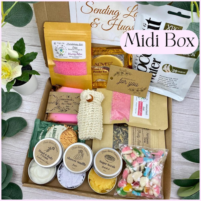 May include: A cardboard gift box containing various items including a yellow pouch of bath salts, a pink soap bar, a beige mesh bag, a coconut water foot mask, a bag of fruit-shaped sweets, and small round tins of hand cream, shower souffl&eacute;, and sugar scrub.