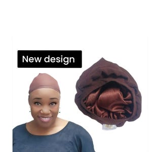 May include: A brown satin-lined bonnet and a matching cap. The bonnet is shown in a close-up view, with the text "New design" in a black rectangle. The bonnet is designed to protect hair.