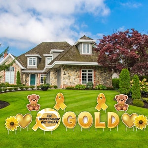 May include: Gold yard signs with teddy bears, sunflowers, hearts, and ribbons. The signs read "In September We Wear Gold".