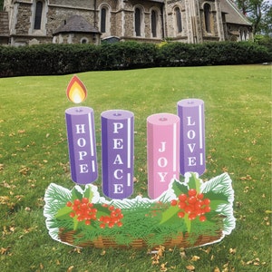 May include: Four purple and pink candles with the words "HOPE", "PEACE", "JOY", and "LOVE" on them. The candles are arranged in a wreath with green pine branches and red berries.