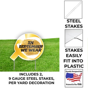 May include: A yellow ribbon with the text "In September We Wear" on a white background. The ribbon is attached to a round, yellow stake. The stake is on a green lawn. The image also shows two steel stakes that are included with the yard decoration.