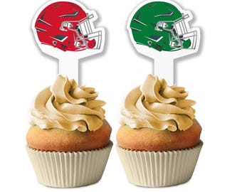May include: Two cupcakes with gold frosting and white cupcake liners. Each cupcake has a football helmet cupcake topper. One topper is red and the other is green.