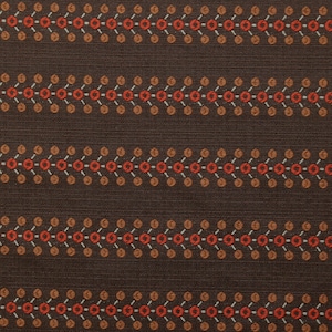 May include: Brown fabric with a repeating pattern of small orange and red circles connected by thin lines. The fabric has a subtle texture.