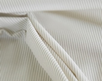 Sharp, crisp, thin tan stripe print on ivory cotton, perfect for drapery, home decor, apparel, upholstery, crafts, etc..