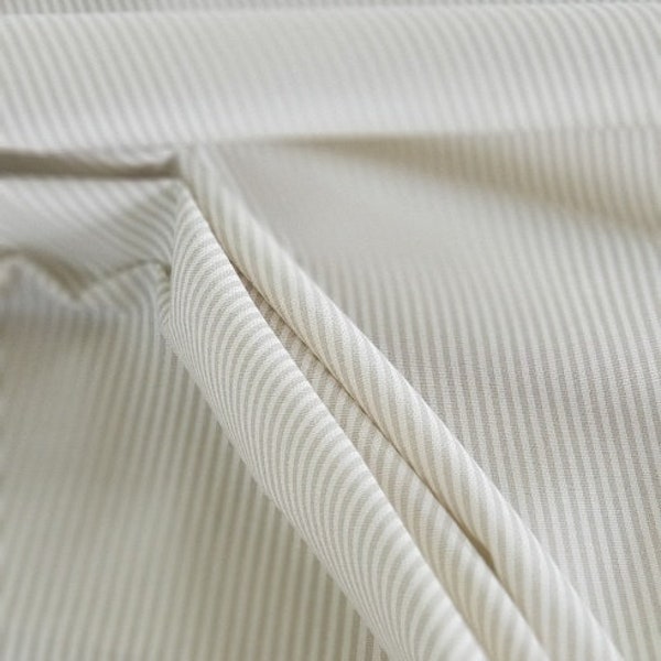 Sharp, crisp, thin tan stripe print on ivory cotton, perfect for drapery, home decor, apparel, upholstery, crafts, etc..