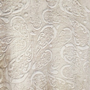 May include: White fabric with an embossed paisley pattern. The fabric has a soft, textured surface.