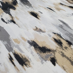 May include: Abstract patterned fabric with a white background and black, gray, and beige brushstrokes.