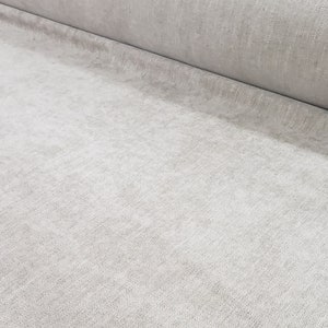 Puede incluir: Primer plano de una tela gris claro con una superficie texturizada.