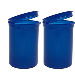 May include: Two blue plastic pill bottles with lids open. The bottles are empty and ready to be filled.