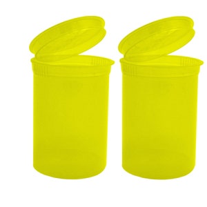 May include: Two bright yellow plastic pill containers with lids open. The containers are empty.