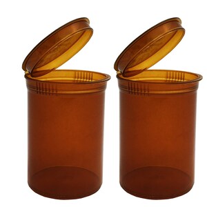 May include: Two amber-colored plastic pill bottles with child-resistant lids. The lids are open and the bottles are empty.