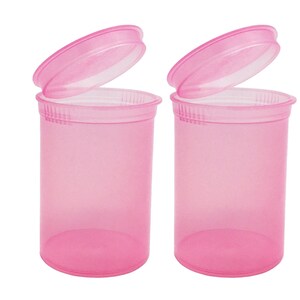 May include: Two pink plastic pill bottles with lids open. The bottles are translucent and have a smooth, rounded shape.