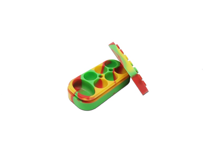 May include: A multi-coloured silicone container with four round compartments and a lid. The container is green, yellow, and red. The lid is green, yellow, and red.