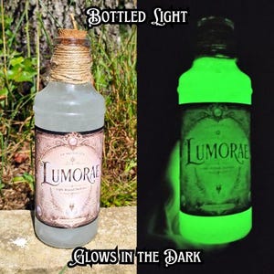 May include: A clear glass bottle with a cork stopper and twine-wrapped neck, featuring a label that reads "LUMORAE" and "Light Beyond Darkness." The bottle contains a liquid that glows bright green in the dark, as shown in the side-by-side view.