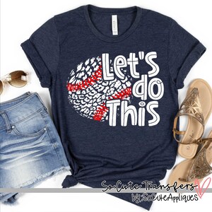 May include: A navy blue t-shirt with a white baseball graphic and the text "Let's do this" in white. The baseball graphic has a red and white leopard print design.