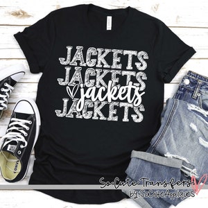May include: Black t-shirt with white text that says "Jackets Jackets Jackets Jackets" with a heart in front of the third word. The shirt is on a white wooden surface with a pair of black converse shoes and a pair of blue jeans.