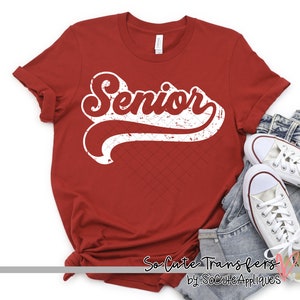 May include: Red t-shirt with a white distressed vintage graphic that says "Senior".
