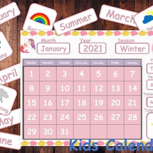 May include: A pink and purple calendar for kids with a mermaid theme. The calendar includes a monthly calendar grid, a section for the day of the week, yesterday, tomorrow, and the weather. The calendar also includes a section for the year, month, and season. The calendar is decorated with seashells, a rainbow, and a mermaid.