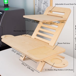 May include: A wooden adjustable standing desk with eight levels of height adjustment. The desk has a 25.6-inch wide surface with a 5.9-inch electronic slot, a 14.17-inch mouse pad area, and two hidden mug holders. The desk is 22.44 inches tall.