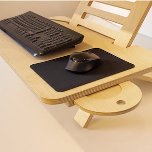 May include: A wooden laptop stand with a black keyboard and mouse. The stand has a built-in drawer for storage.