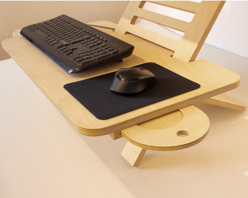 May include: A wooden laptop stand with a black keyboard and mouse. The stand has a built-in drawer for storage.