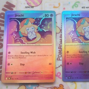 Peut inclure: Deux cartes à collectionner holographiques avec Jirachi, sur un fond coloré. Les cartes comportent les textes "Jirachi", "Swelling Wish" et "Slap". L'une est étiquetée "new ver" et l'autre "old ver".