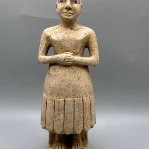 Ancient near eastern praises position Bald male statue of limestone