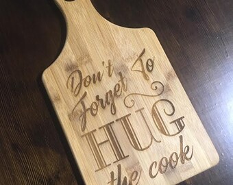 Hug the Cook engraved cutting board - Great mothers day cutting board gift - Cook Gift - Engraved Paddle Handled Cutting Board