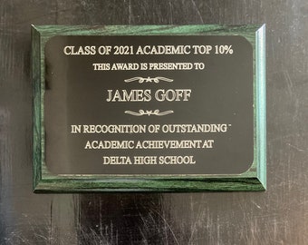 May include: A green plaque with a black background and gold lettering. The plaque reads "Class of 2021 Academic Top 10%". This award is presented to James Goff in recognition of outstanding academic achievement at Delta High School.