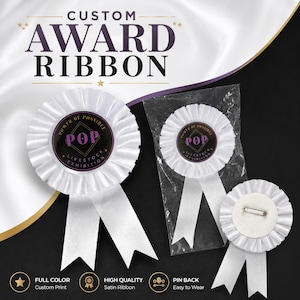 May include: Three white satin award ribbons with pleated edges and two hanging tails. Each features a circular center with the text "POWER OF POSSIBLE POP LIVESTOCK EXHIBITION" in black, gold, and purple. One ribbon is shown from the back with a metal pin.