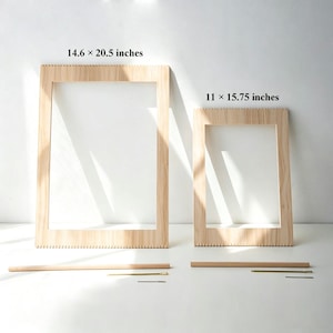 Può includere: Due telai rettangolari in legno con bordi dentellati. Il telaio più grande è etichettato 14,6 x 20,5 pollici, mentre quello più piccolo è etichettato 11 x 15,75 pollici. Ogni telaio è accompagnato da un'asta in legno e un piccolo ago in metallo.