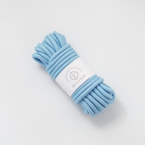 May include: A bundle of light blue macrame cord, tightly wound and secured with a white label. The label features text and a small graphic. The cord appears to be approximately 8mm in diameter, suitable for various crafting projects.