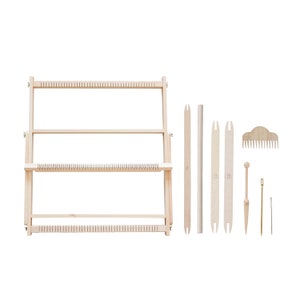 May include: A wooden weaving loom kit with various tools. The kit includes a rectangular frame, weaving tools, a comb, and a needle. The items are made of light-colored wood and are arranged on a white background.