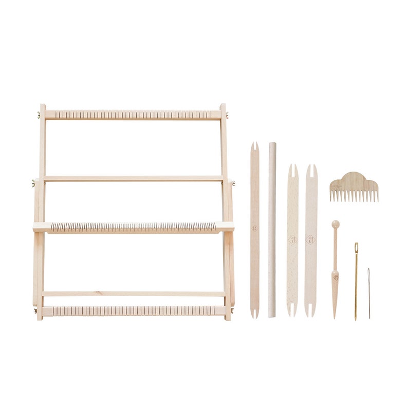 May include: A wooden weaving loom kit with various tools. The kit includes a rectangular frame, weaving tools, a comb, and a needle. The items are made of light-colored wood and are arranged on a white background.