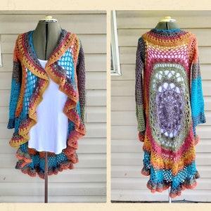 May include: A long, multi-colored crochet cardigan with a ruffled hem and a large crocheted circle design on the back.