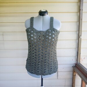 May include: A green crochet tank top with a delicate openwork pattern. The top is displayed on a mannequin.