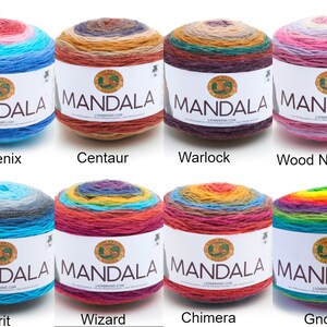 May include: Eight skeins of Lion Brand Mandala yarn in various color combinations. The yarn is arranged in two rows of four skeins. The colors include blue, teal, pink, orange, red, yellow, green, and purple. The yarn is labeled "MANDALA" with the Lion Brand logo.