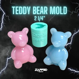 May include: A teal silicone mold for making 2 1/4 inch teddy bear shaped resin crafts. The mold is shown with two finished resin teddy bears, one pink and one light blue.