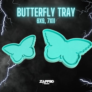 May include: Two turquoise butterfly-shaped resin trays. The larger tray is 7 inches by 11 inches and the smaller tray is 6 inches by 9 inches.  The trays are perfect for holding jewelry, keys, or other small items.