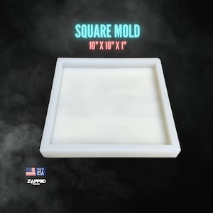 May include: A white square mold with the text "SQUARE MOLD 10" X 10" X 1"" in blue and red. The mold is 10 inches by 10 inches by 1 inch. The image also includes the text "MADE IN USA" and the ZAPPED Design logo.
