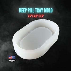May include: White silicone mold for making a deep pill tray. The mold is oval shaped and measures 7.5 inches by 4.5 inches by 1.5 inches.
